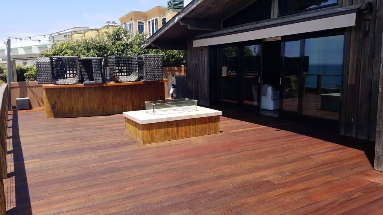 A wood deck with a fire pit- Deck Painting in San Diego